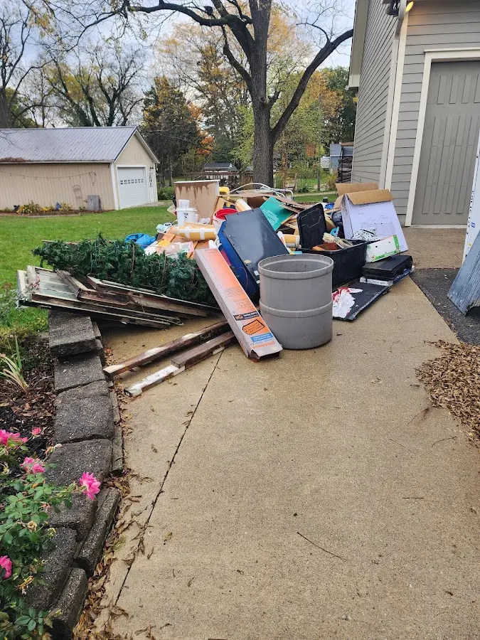 Dumpster being loaded with debris for 3 Yard Dumpster Rental in Aurora